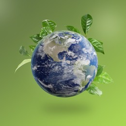 Image of Recycling concept. Earth planet with green leaves on color background