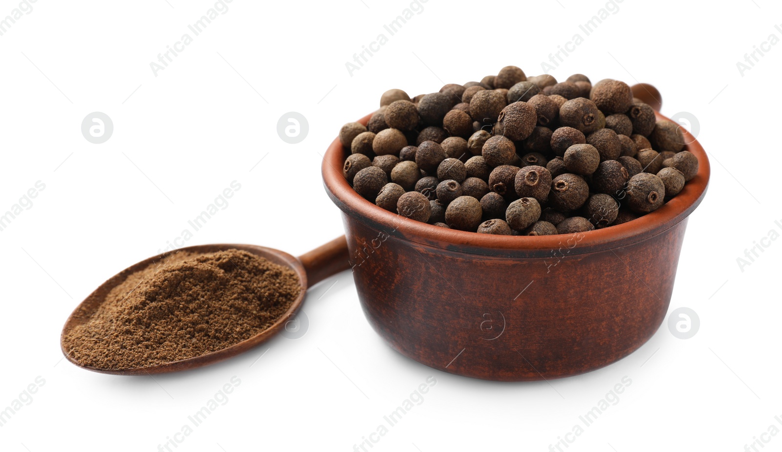 Photo of Aromatic ground allspice pepper, grains and spoon isolated on white