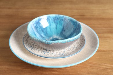 Photo of Elegant new empty dishes on wooden table