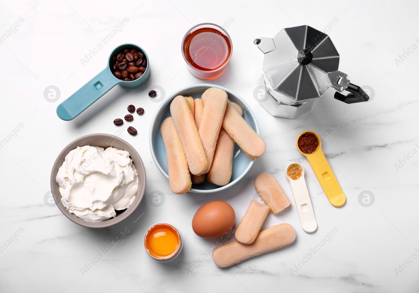 Photo of Flat lay composition with ingredients for tiramisu on white table