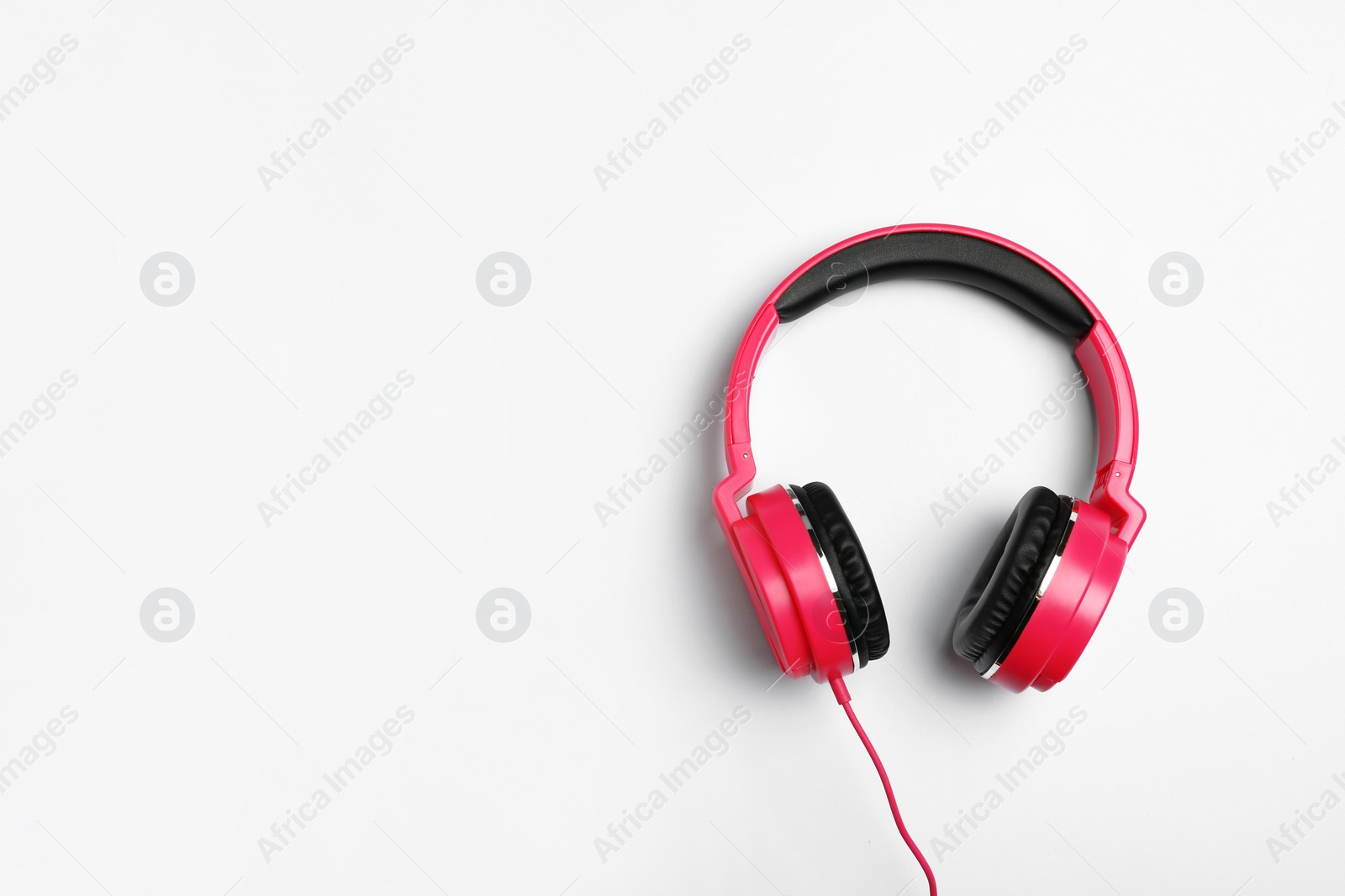 Photo of Stylish modern headphones on white background, top view