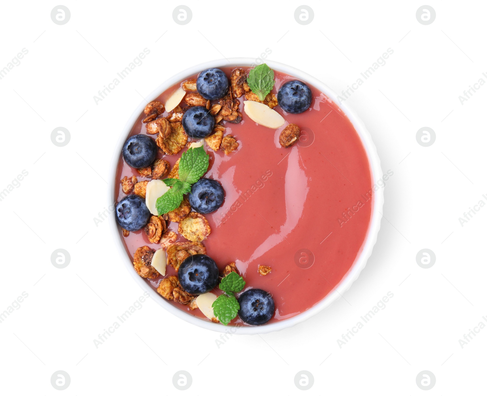 Photo of Bowl of delicious smoothie with fresh blueberries and granola isolated on white, top view
