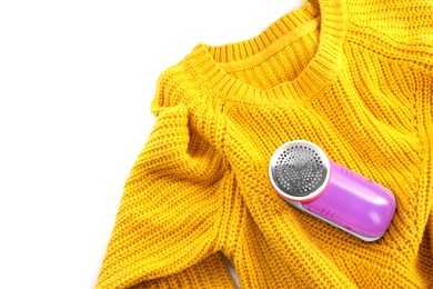 Modern fabric shaver and woolen sweater on white background, top view