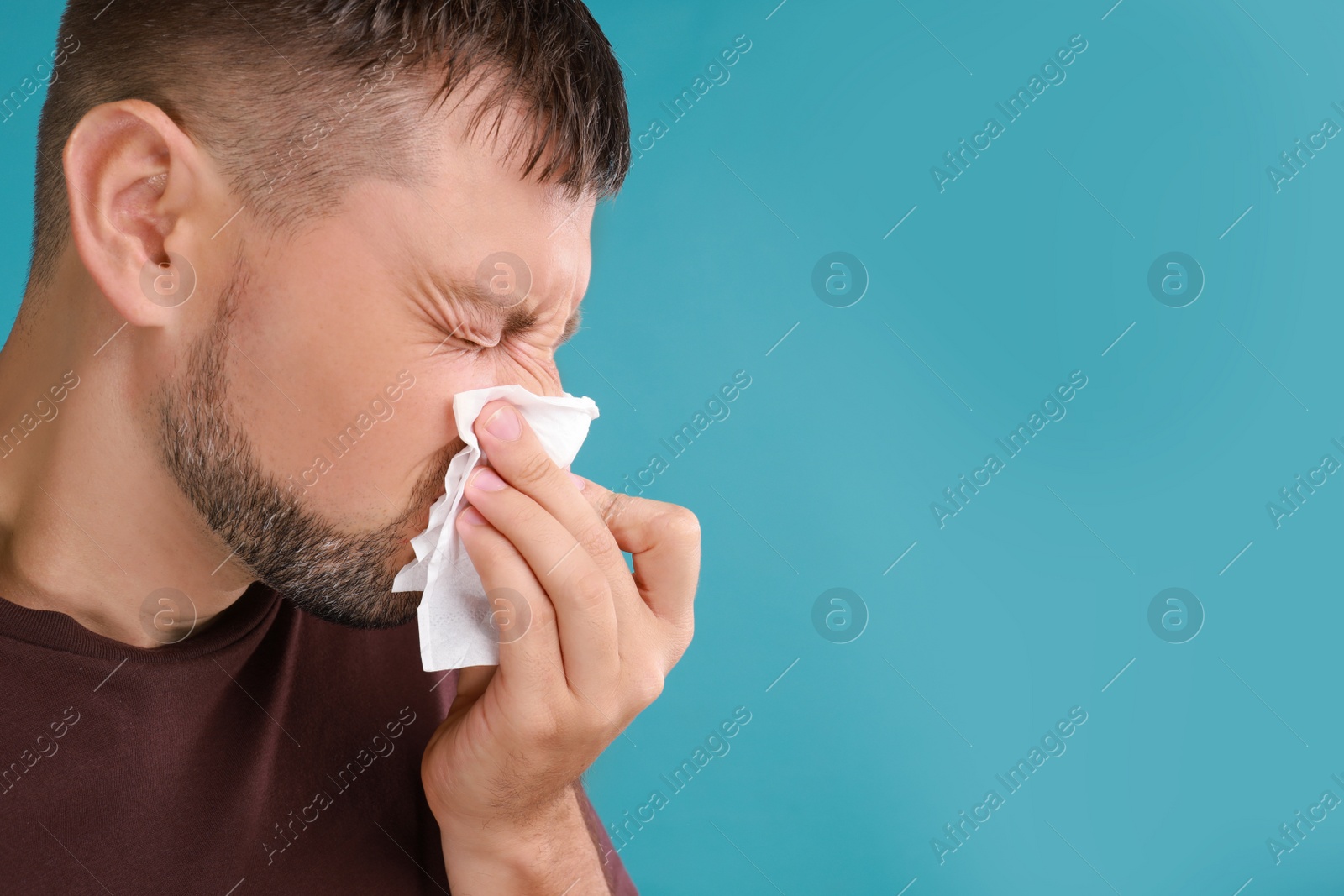 Photo of Man suffering from allergy on blue background. Space for text