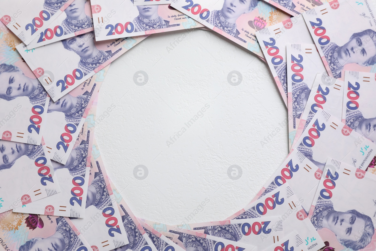 Photo of Frame of Ukrainian money on white background, flat lay. Space for text