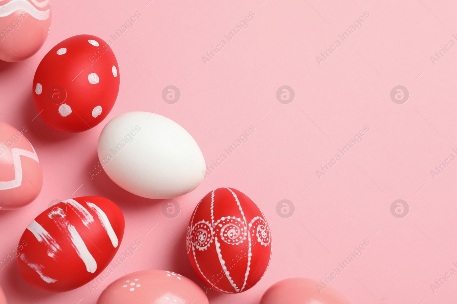 Photo of Flat lay composition with painted Easter eggs on color background, space for text