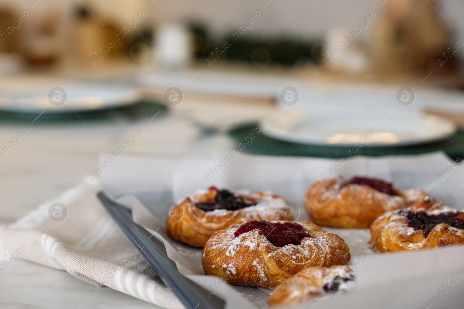 Photo of Tasty Christmas cookies on white marble table in kitchen, closeup. Space for text