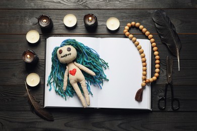 Photo of Flat lay composition with voodoo doll on dark wooden table
