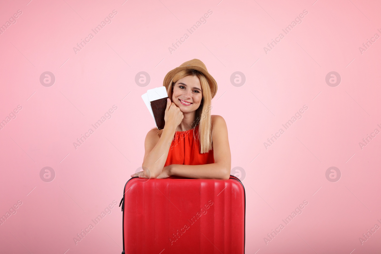 Photo of Woman with suitcase and passport on color background. Vacation travel