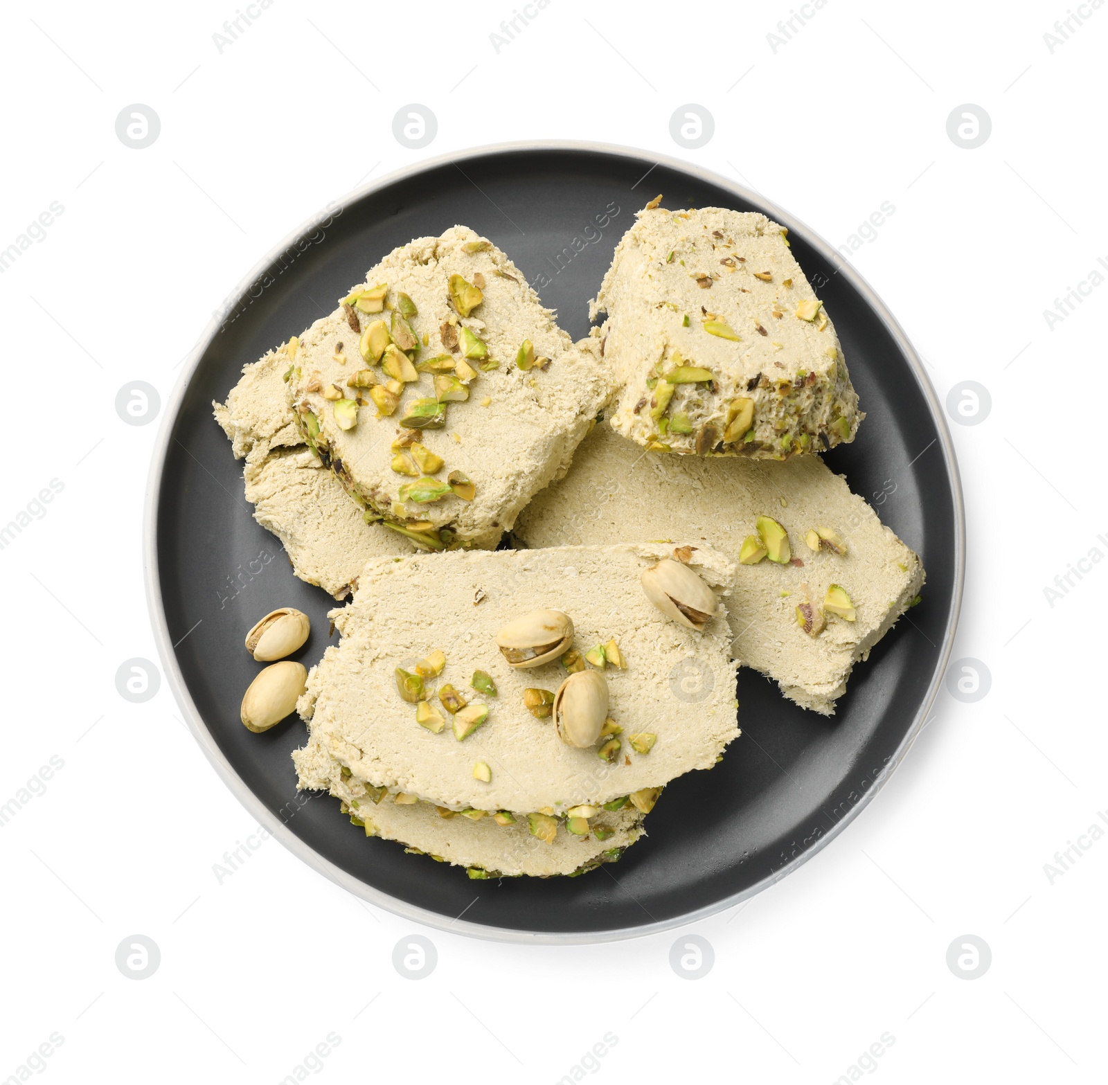 Photo of Pieces of tasty halva with pistachios on white background, top view