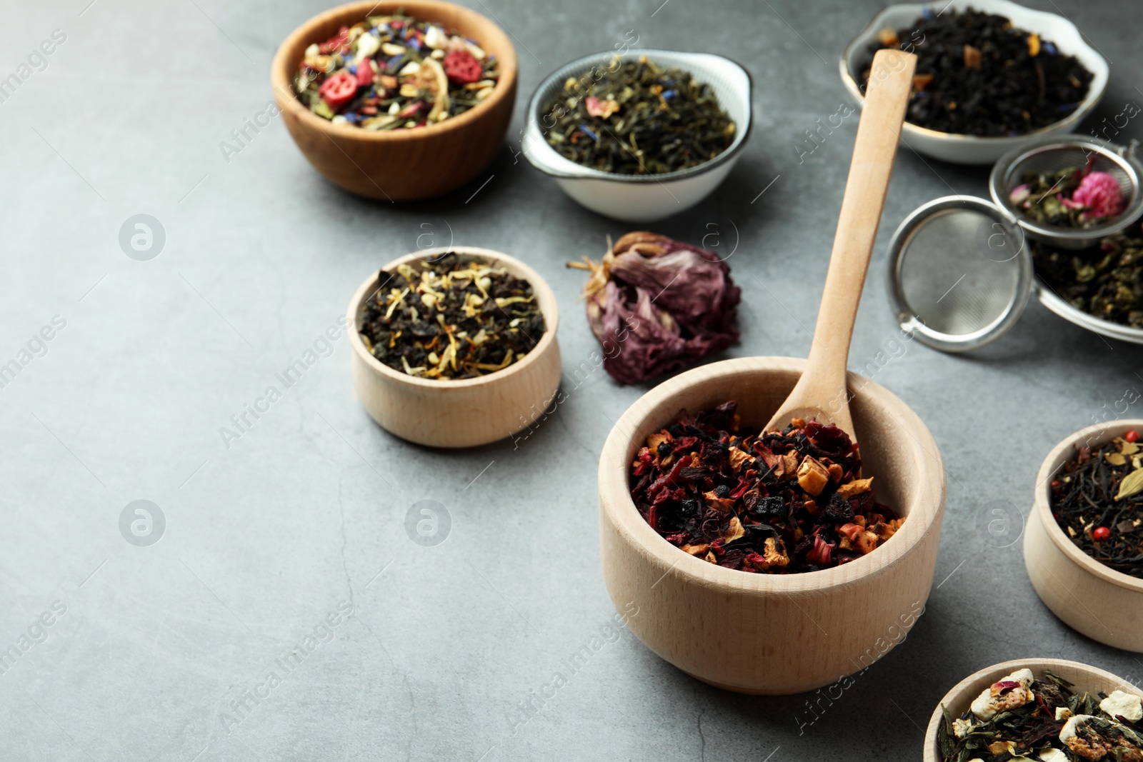 Photo of Many different herbal teas on grey table