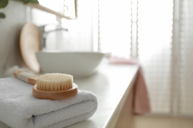 Hairbrush on towel on countertop in bathroom