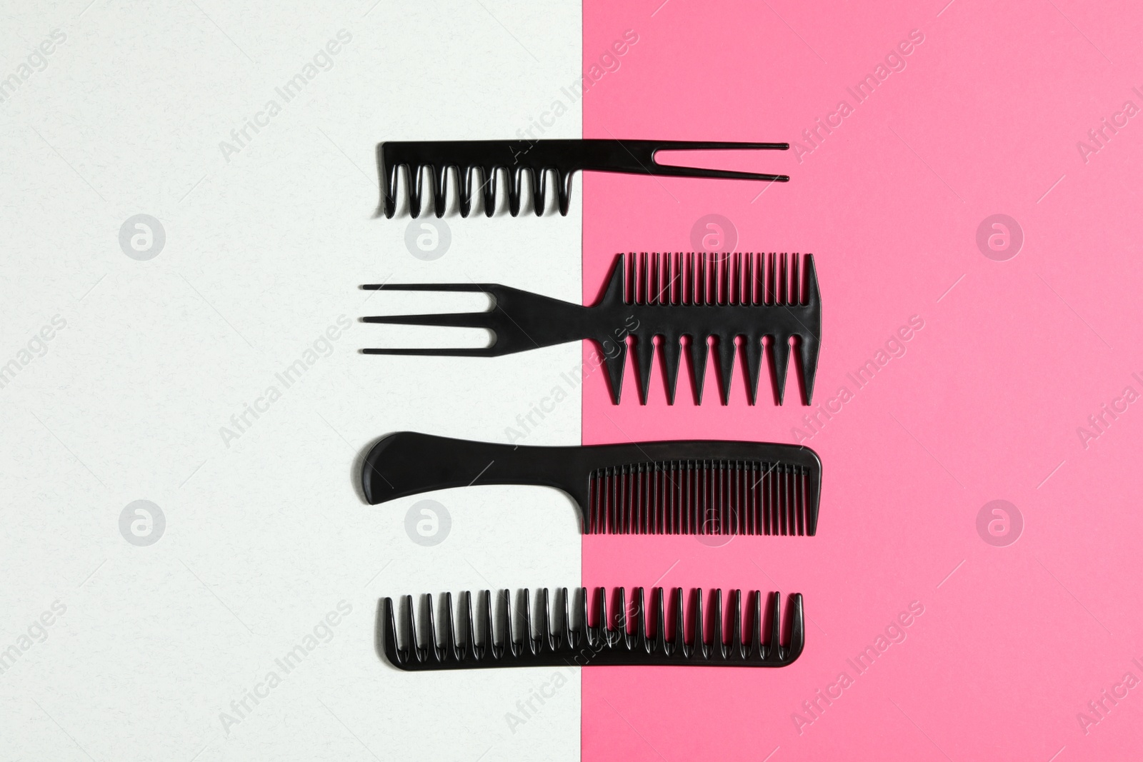 Photo of Set of black combs on color background, flat lay