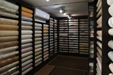 Photo of Assortment of stylish wall papers in shop