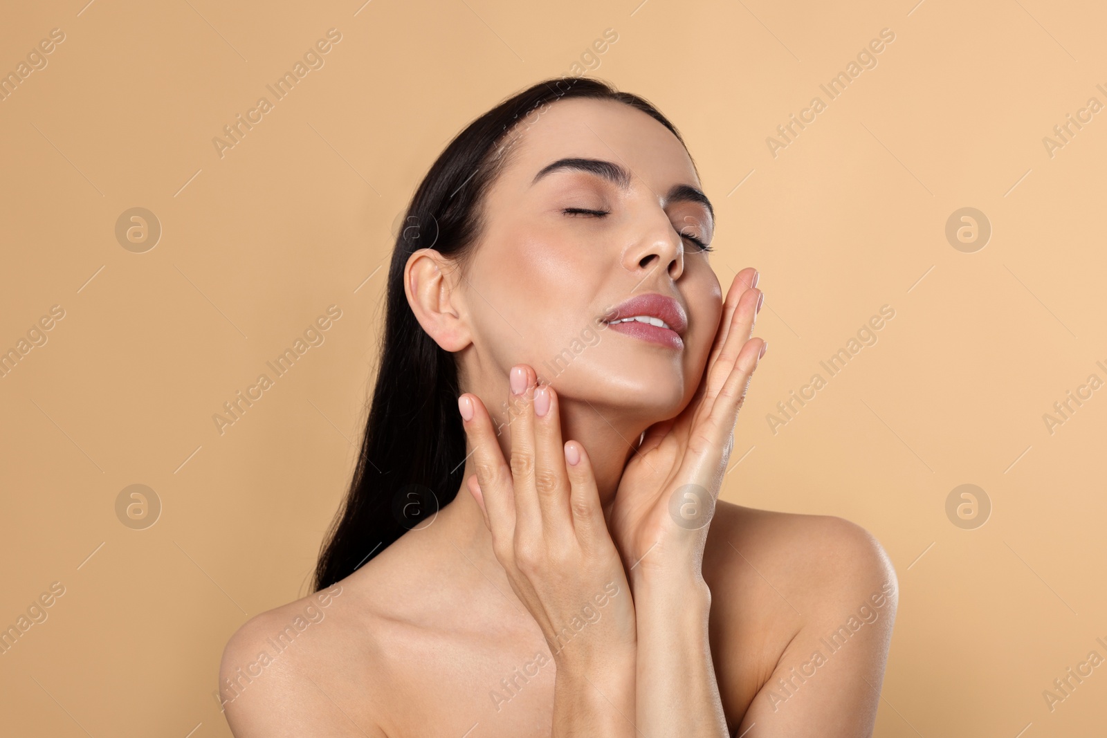 Photo of Portrait of attractive young woman on beige background. Spa treatment