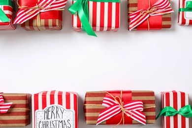 Photo of Different Christmas gift boxes on white background, flat lay. Space for text