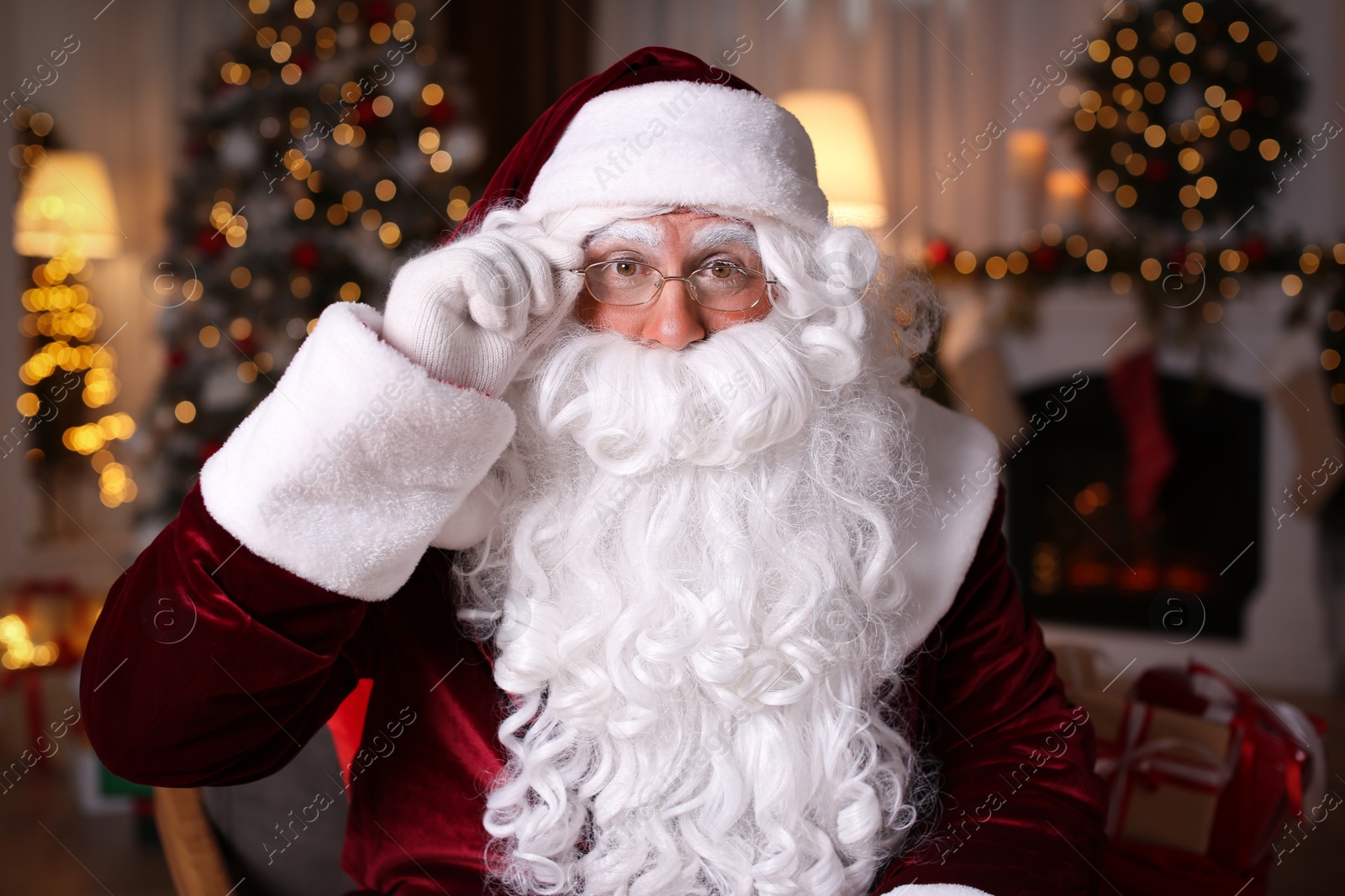 Photo of Santa Claus in room decorated for Christmas