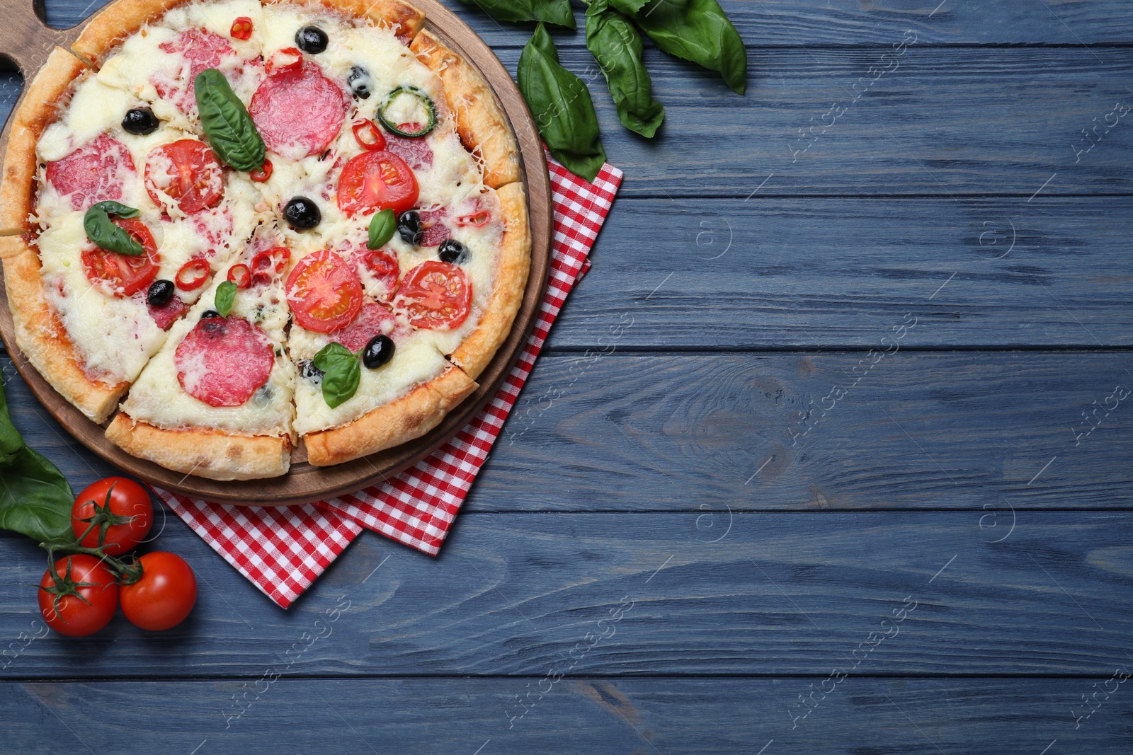 Photo of Flat lay composition with delicious pizza Diablo on wooden background. Space for text