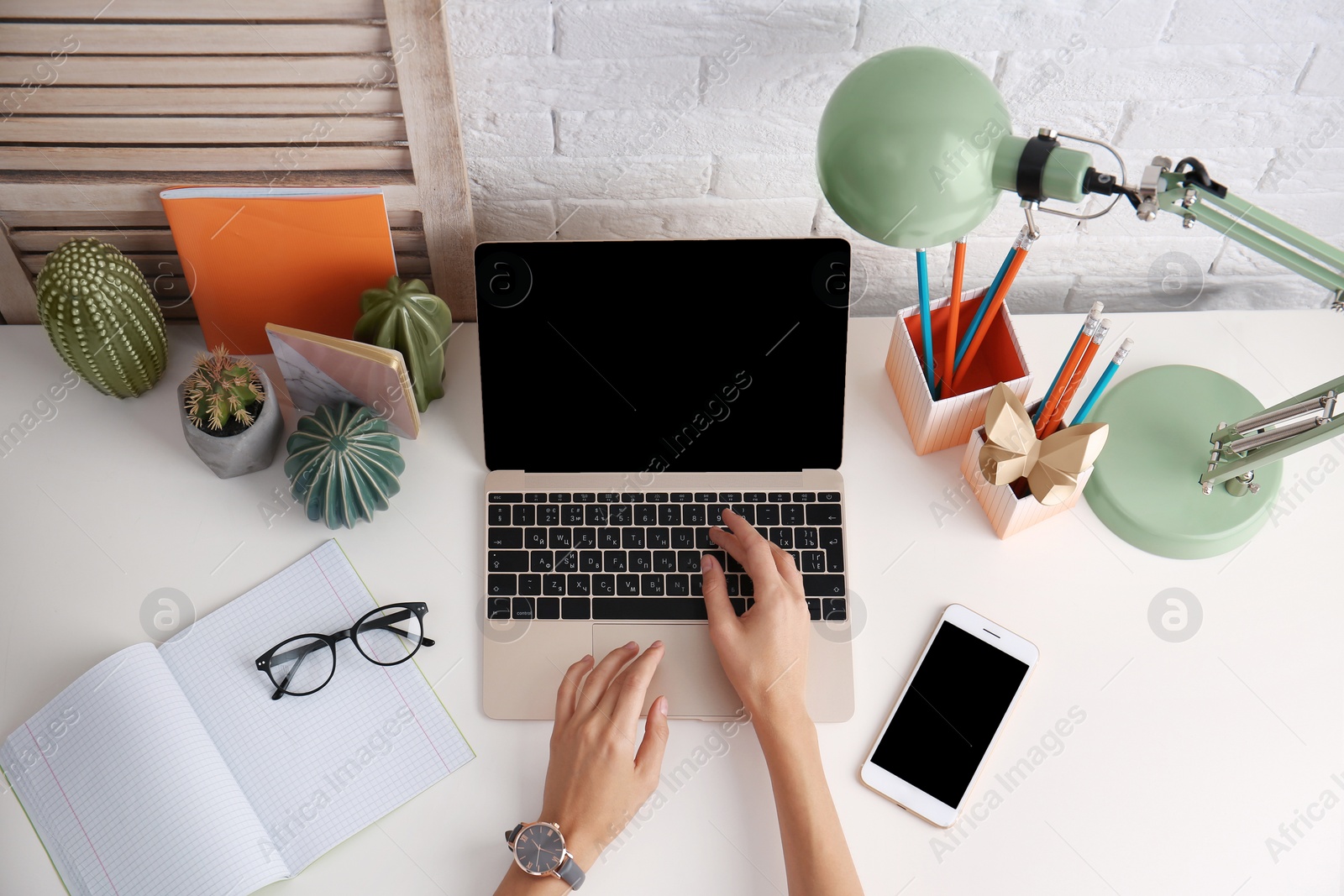 Photo of Woman using with laptop at table, above view. Mockup for design