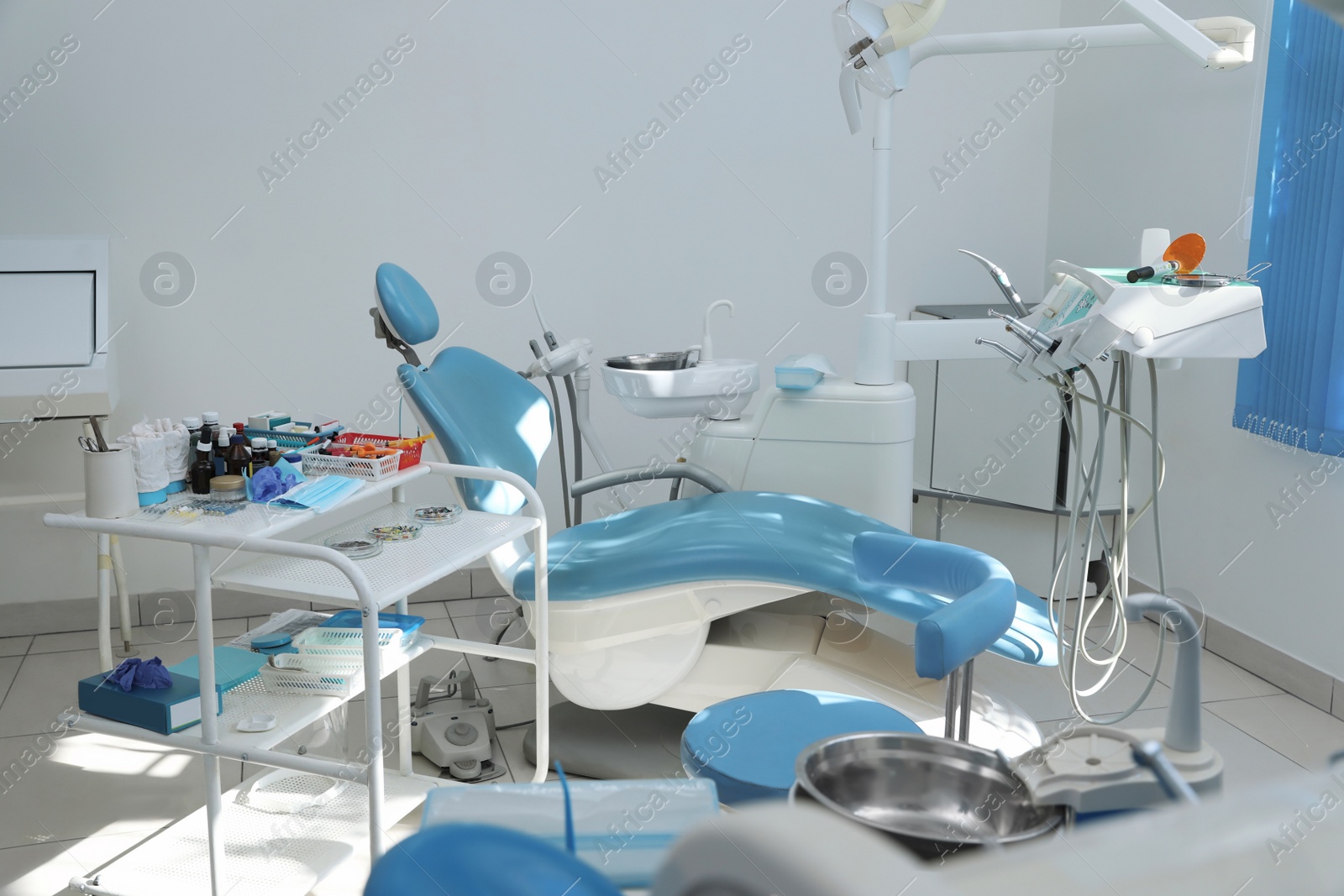 Photo of Dentist's office interior with chair and modern equipment