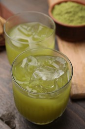 Photo of Delicious iced green matcha tea on wooden table, closeup