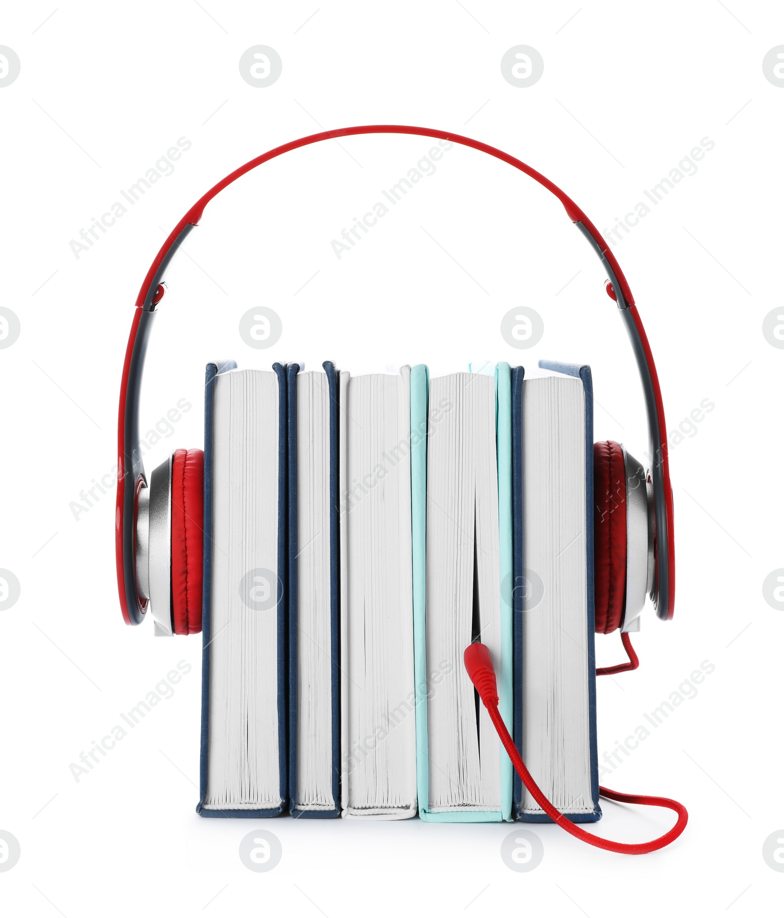 Photo of Modern headphones with hardcover books on white background