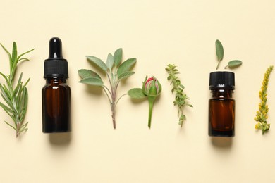 Bottles of essential oils, different herbs and rose bud on beige background, flat lay