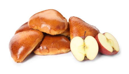 Delicious baked apple pirozhki and fruits on white background