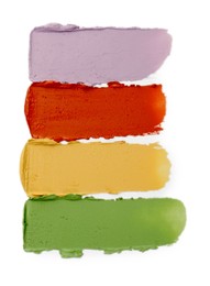 Photo of Samples of color correcting concealers isolated on white, top view