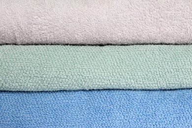 Photo of Stack of clean soft towels as background, closeup