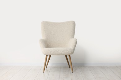 Photo of Comfortable armchair near white wall in room