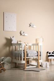 Photo of Cute baby room interior with modern crib and toys