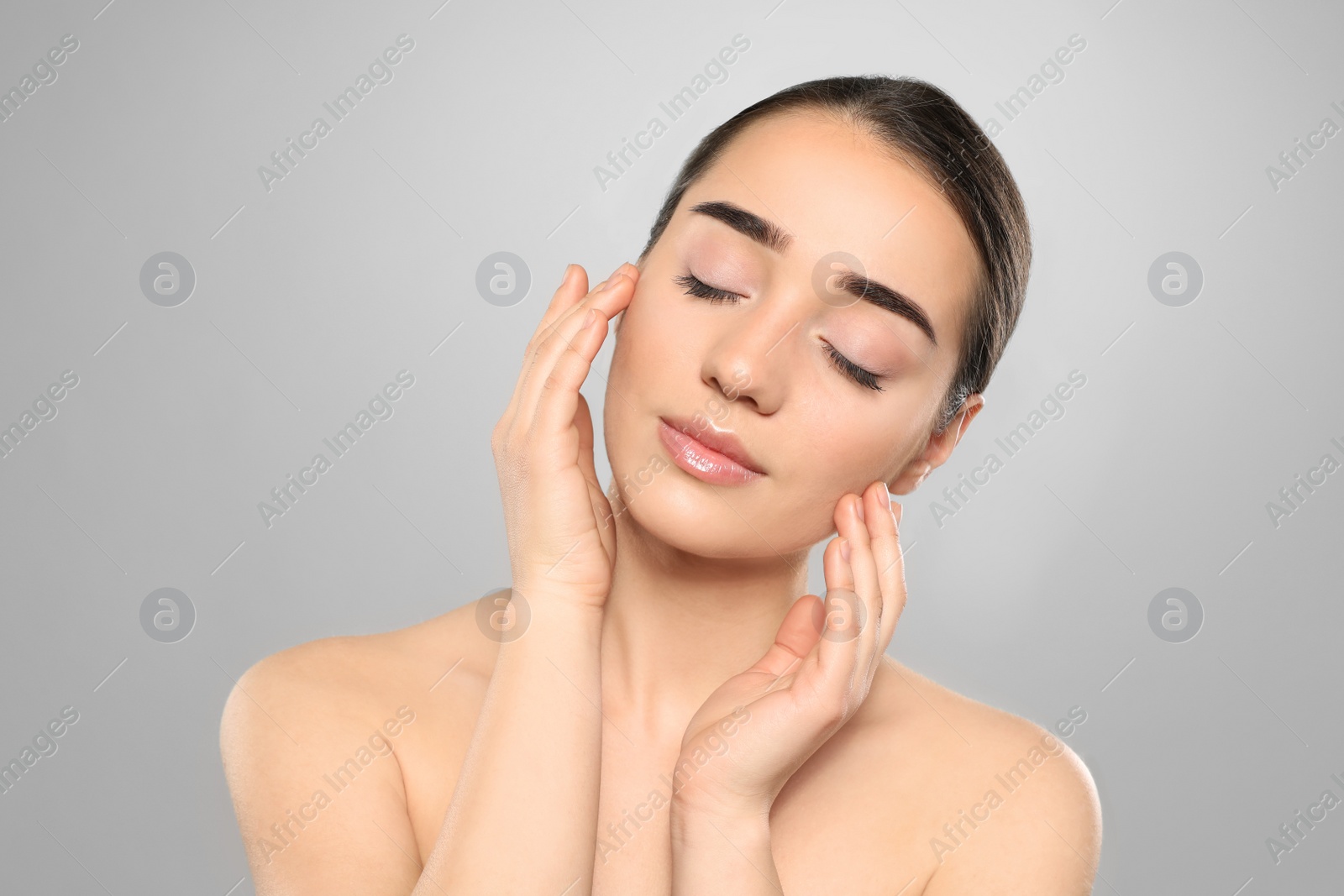 Photo of Portrait of young woman with beautiful face against color background