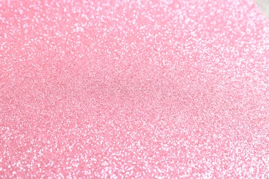 Photo of Beautiful pink shiny glitter as background, top view