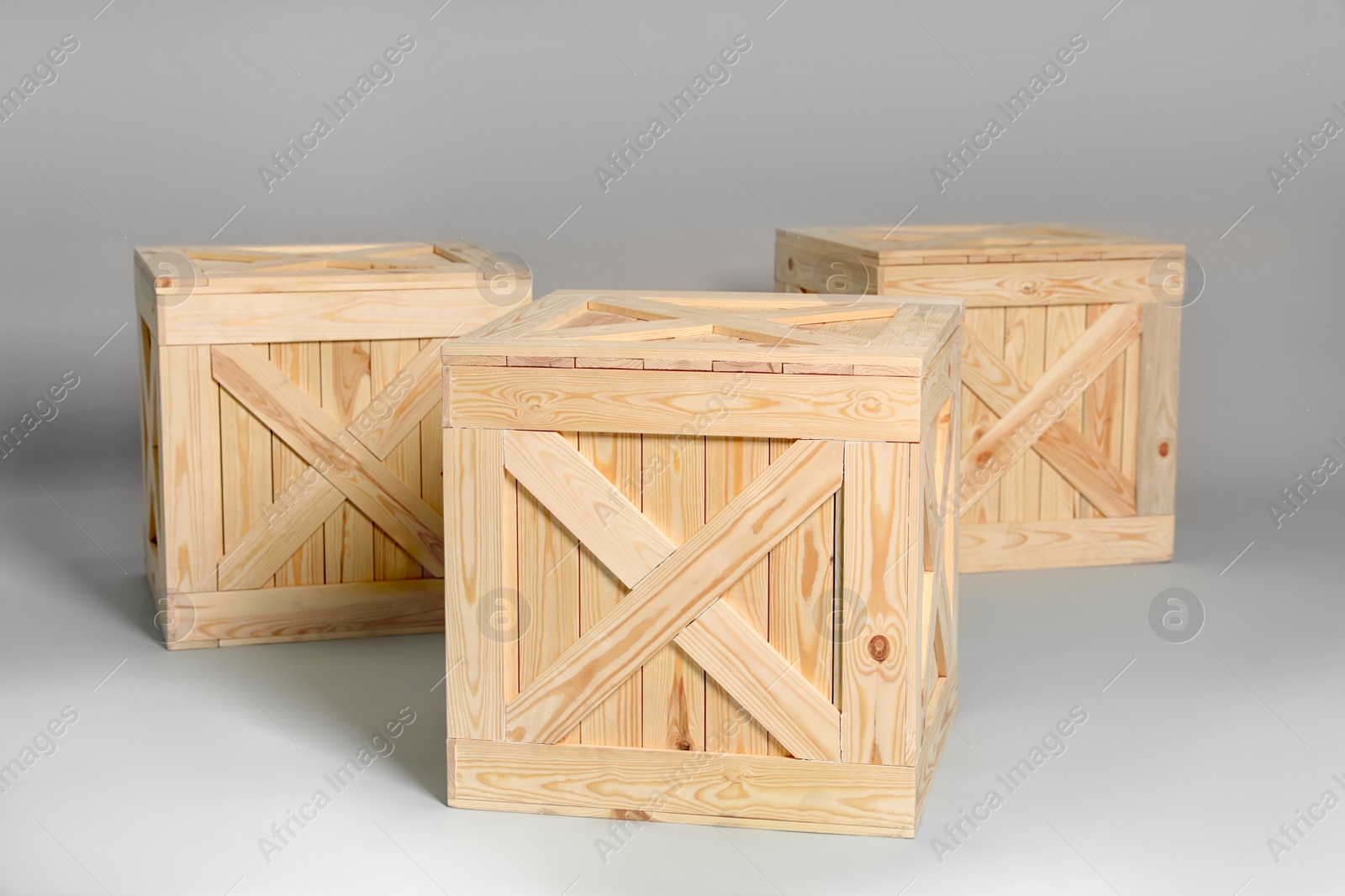 Photo of Group of wooden crates on grey background