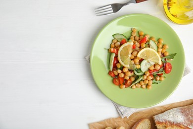 Photo of Delicious fresh chickpea salad served on white wooden table, flat lay. Space for text