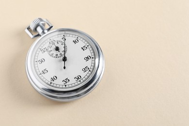 Photo of Vintage timer on beige background, space for text. Measuring tool
