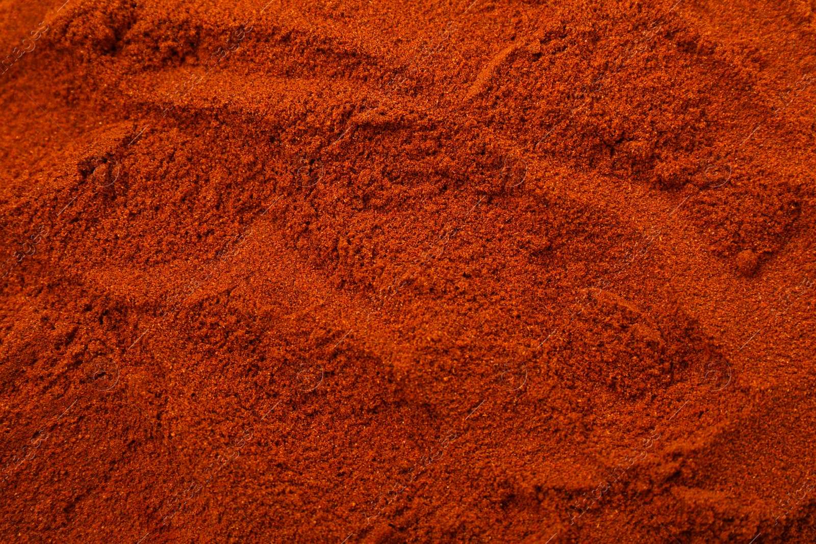 Photo of Aromatic paprika powder as background, top view