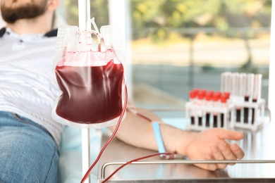 Man making blood donation at hospital, closeup
