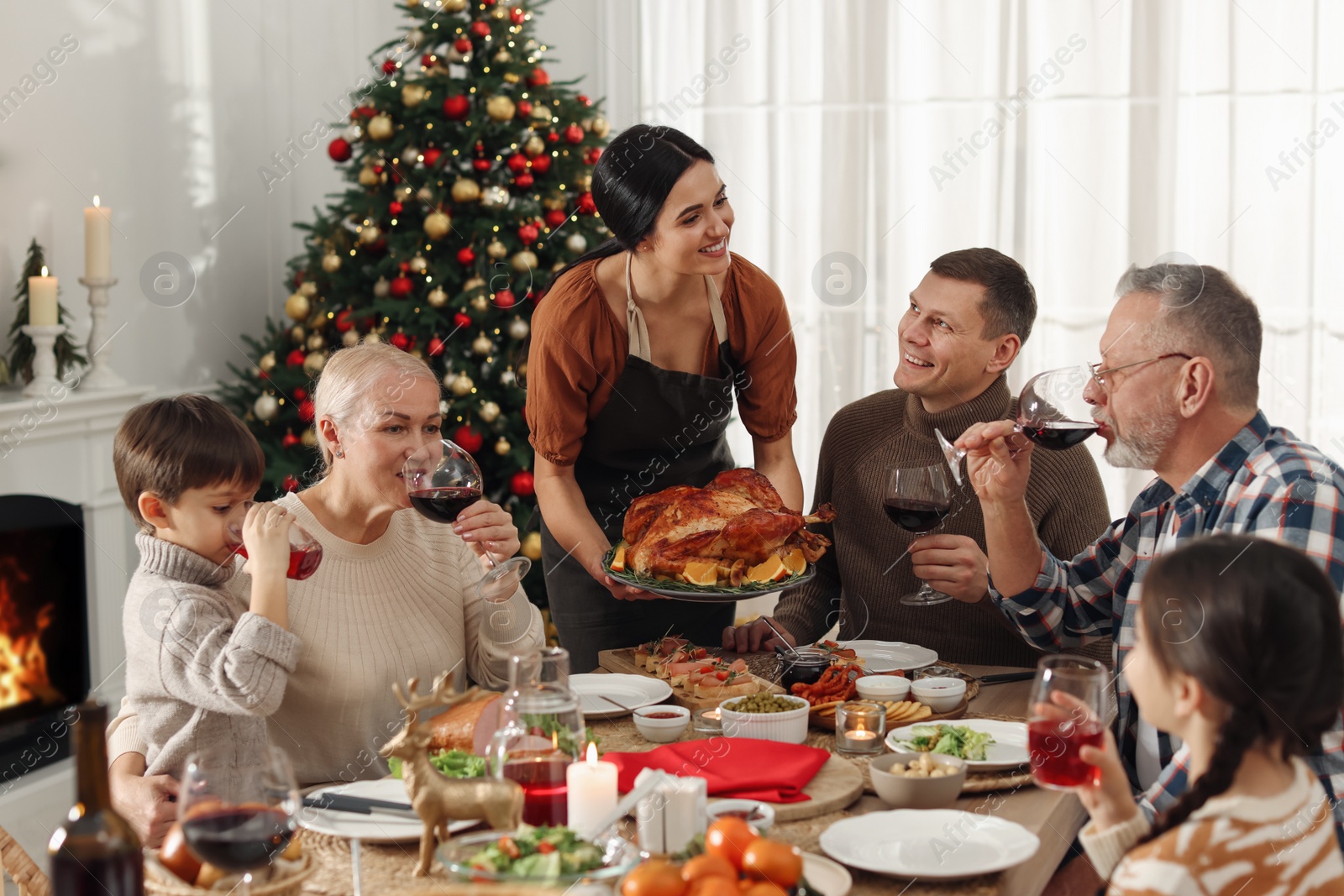 Photo of Happy family enjoying festive dinner at home. Christmas celebration