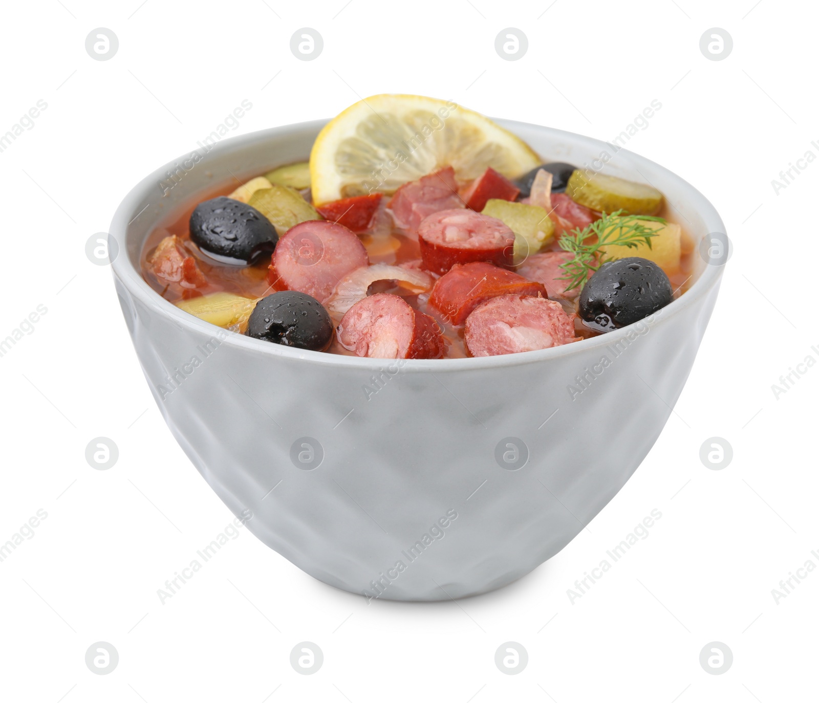 Photo of Meat solyanka soup with thin dry smoked sausages in bowl isolated on white