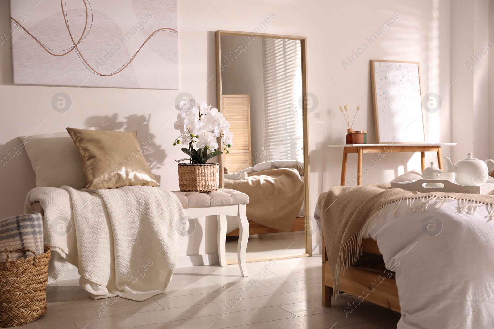 Photo of Beautiful bedroom interior with potted white orchids