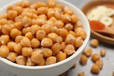 Photo of Delicious chickpeas on table, closeup. Hummus ingredient