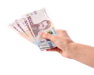 Photo of Woman holding Ukrainian money on white background, closeup