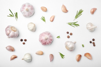 Flat lay composition with garlic on light background