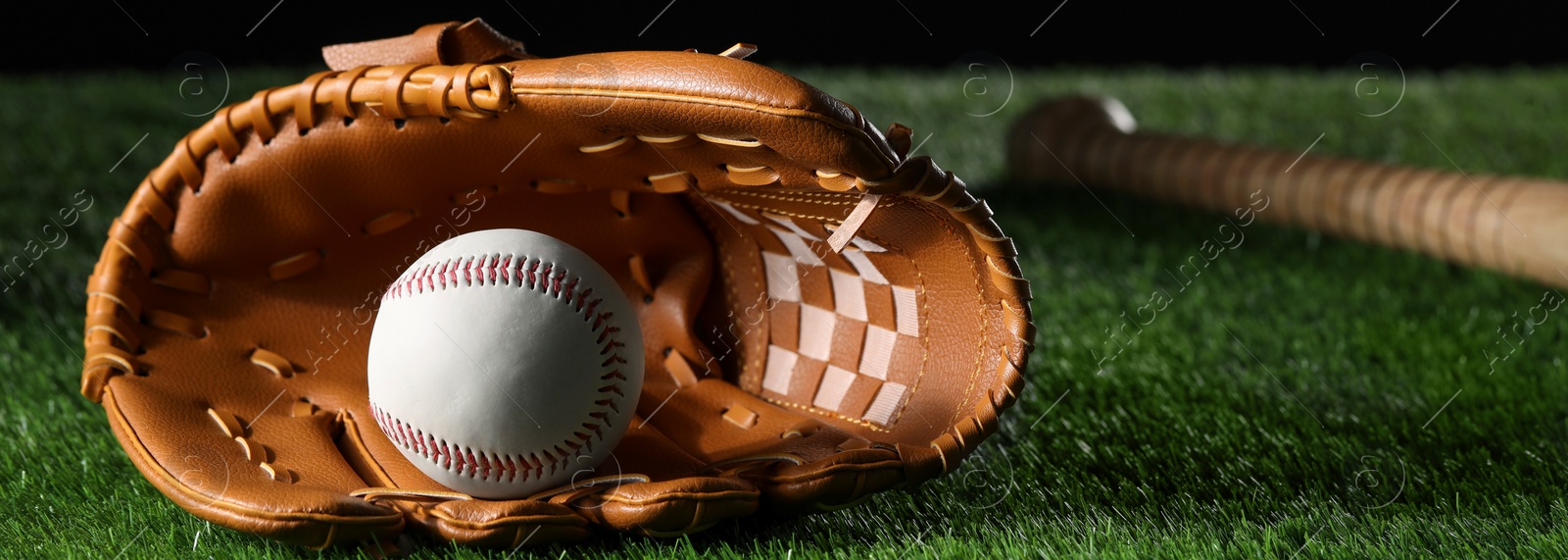 Image of Baseball glove and ball on green grass, space for text. Banner design