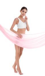 Photo of Young woman covering her body with silk fabric on white background. Beauty care