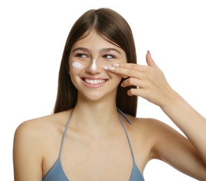 Photo of Teenage girl applying sun protection cream on her face against white background