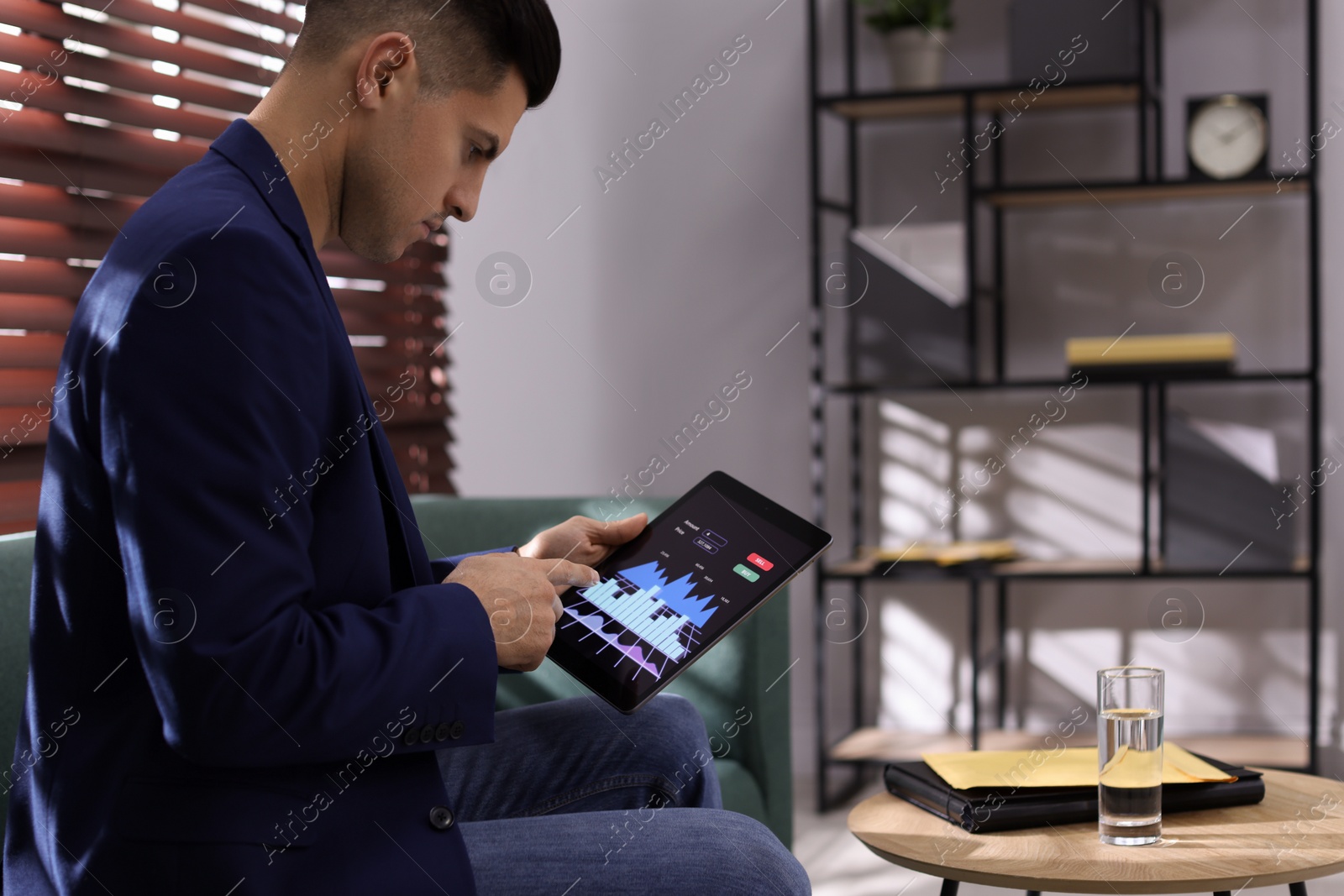 Photo of Businessman working with tablet in office, space for text. Forex trading