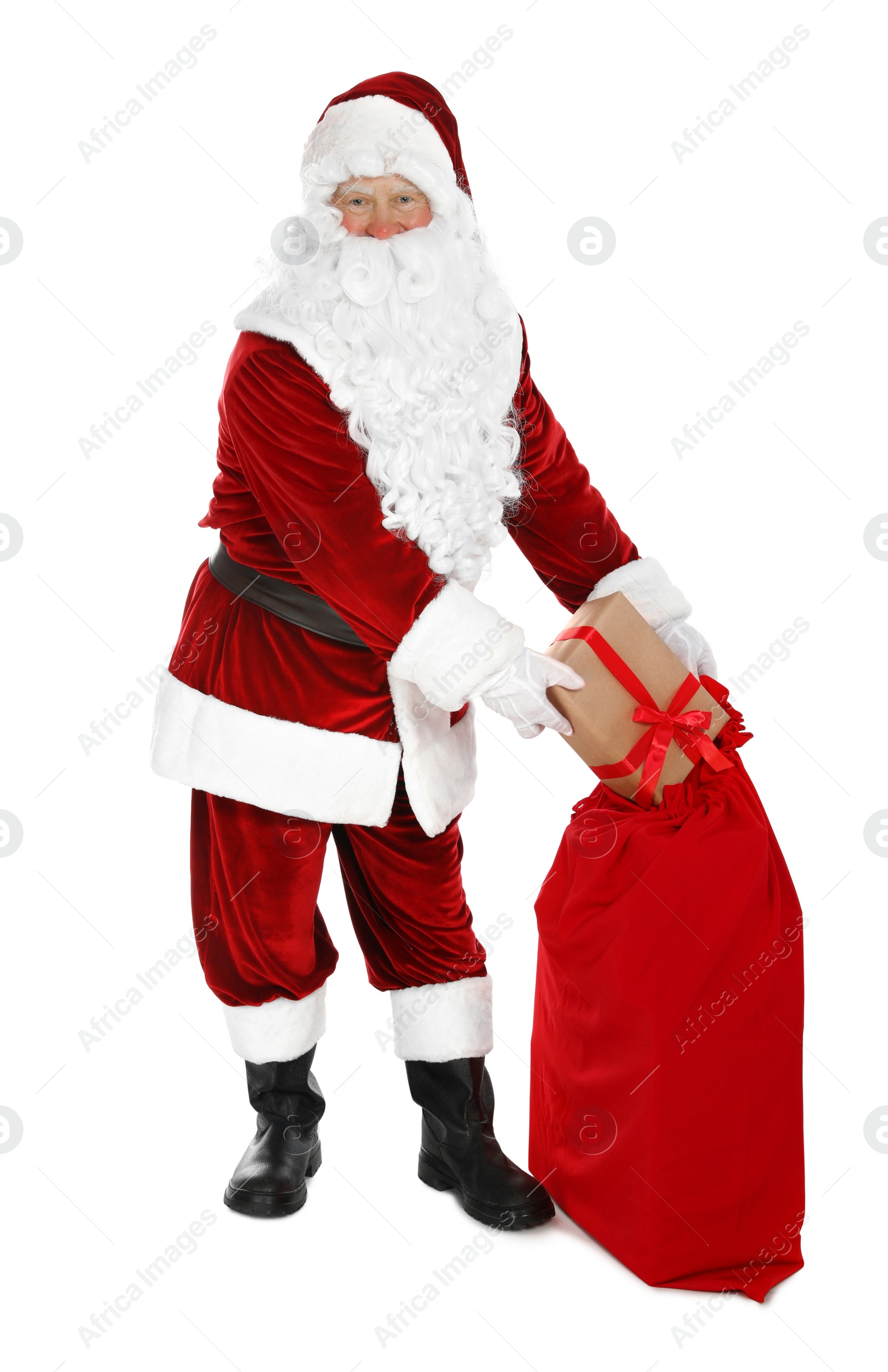Photo of Authentic Santa Claus with sack and gifts on white background